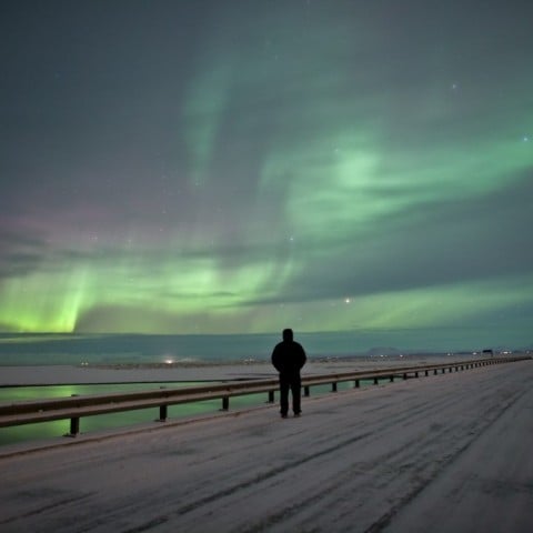 Watching the Northern Lights on a bridge